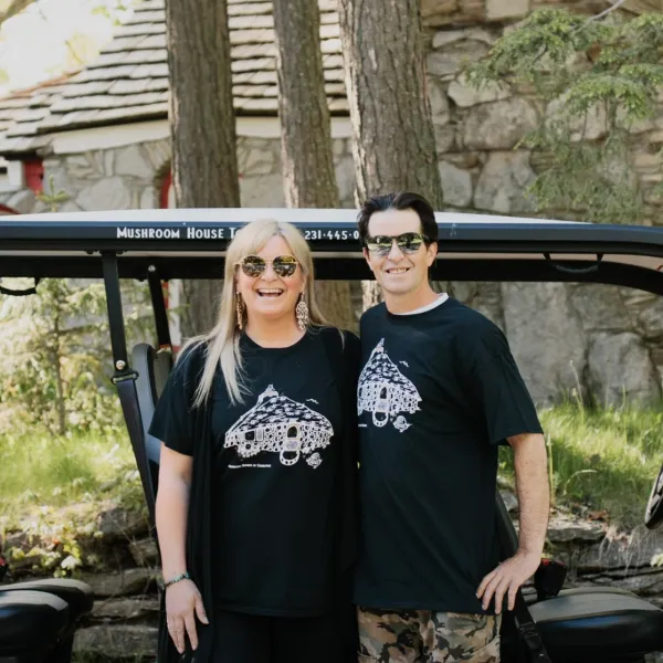 a person standing in front of a group of people posing for the camera