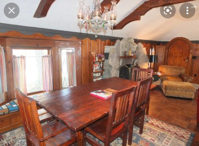 a kitchen with wooden cabinets and a dining room table