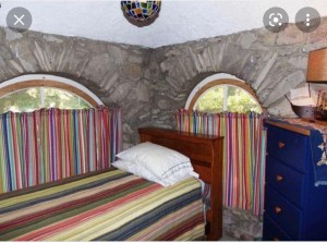 a bedroom with a bed and a painting on the wall